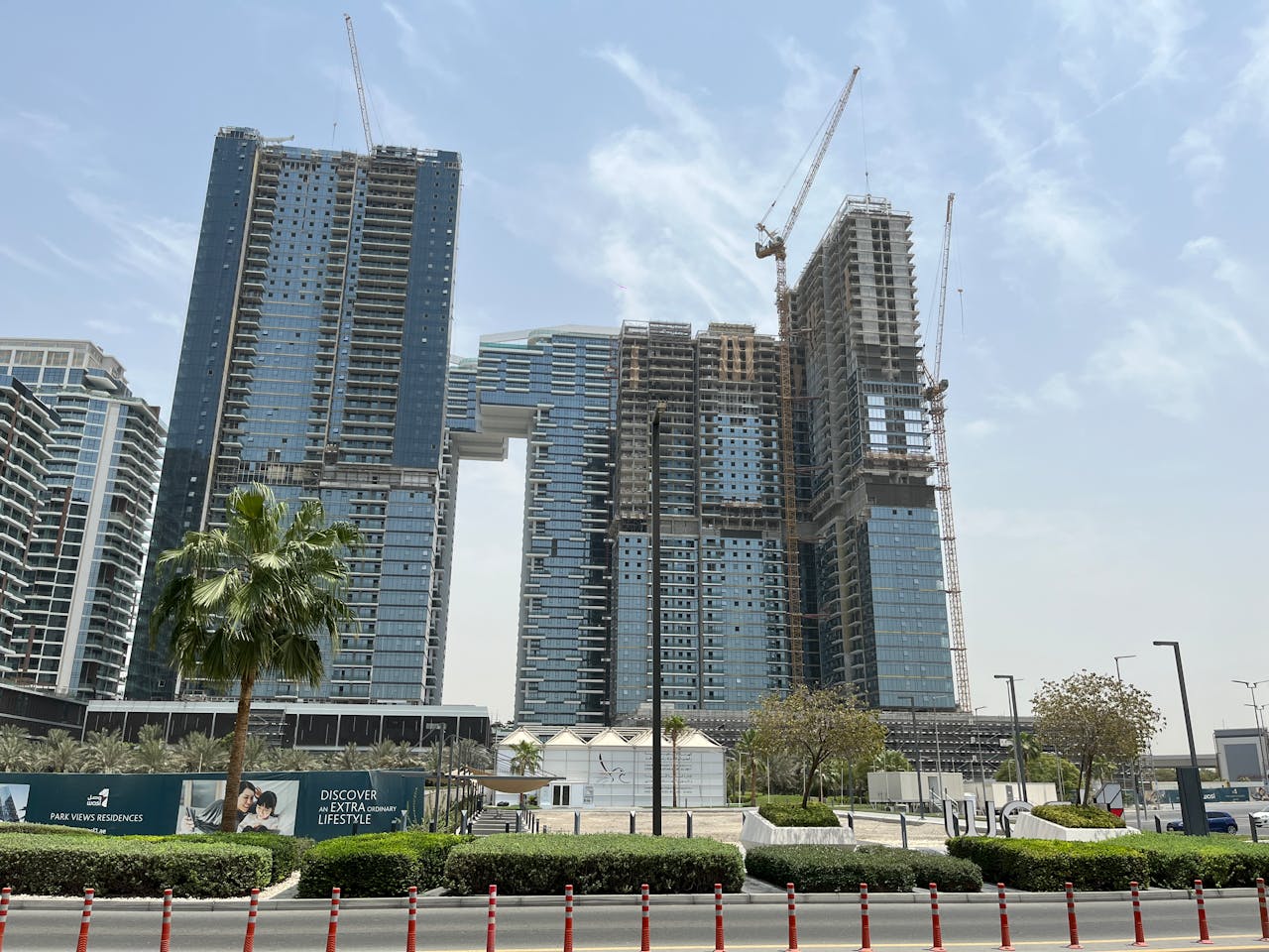 View of modern skyscraper construction with cranes in Dubai.