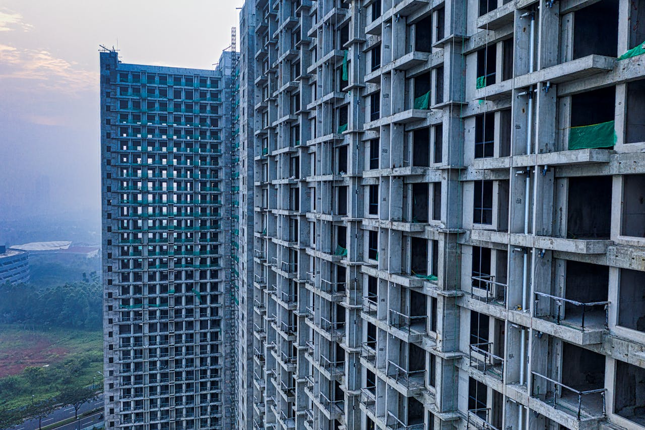 Home Skyline view of unfinished concrete high-rise buildings in Banten, Indonesia against a misty sky.